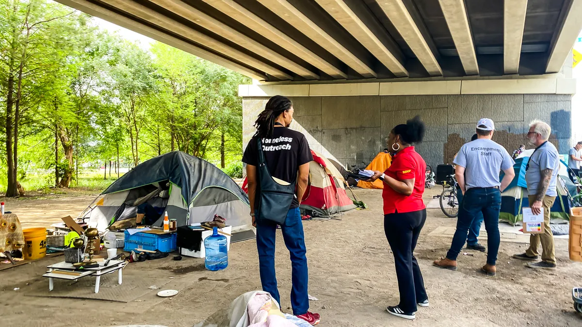 Homeless outreach coordinators at an encampment in Houston.