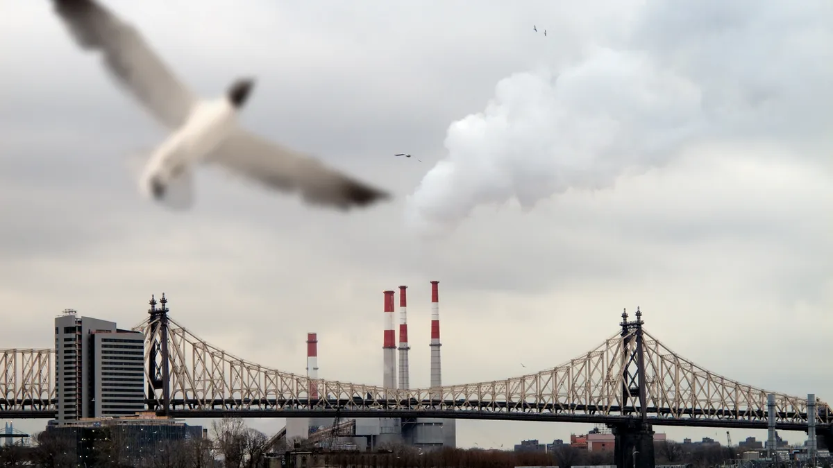 Queensboro Bridge and factory with tall chimneys