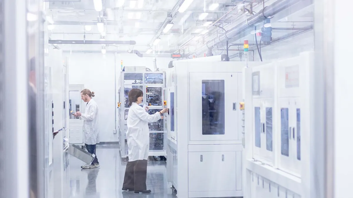 Lab assistants work in the cell assembly room at the Batteries and Energy to Advance Commercialization and National Security prototyping facility at The University of Texas at Dallas.