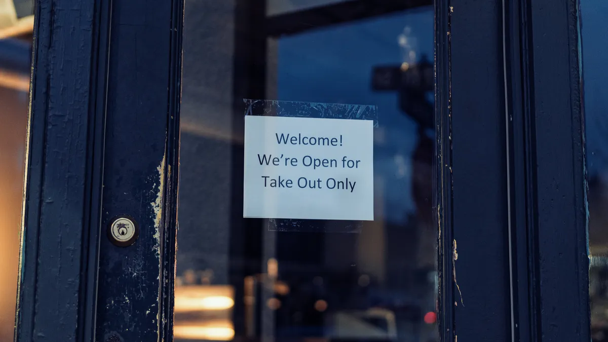 Restaurant in Minneapolis, Minnesota partially closed, only open for take-outs, during the COVID-19 coronavirus pandemic, with a sign