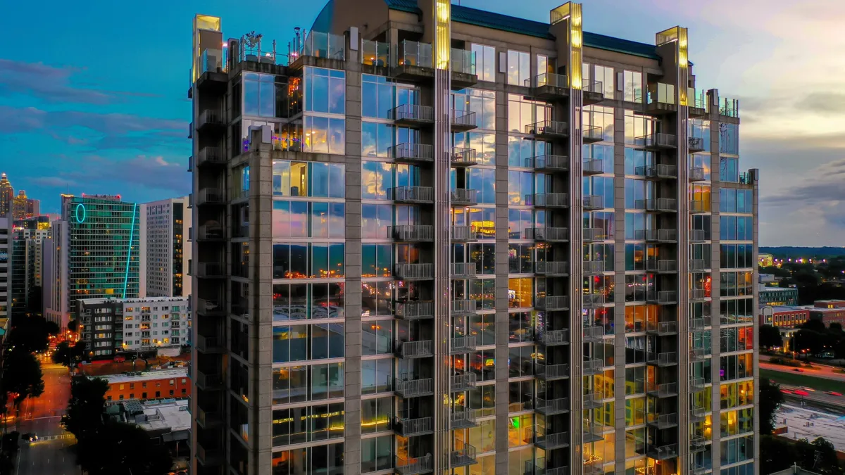 Apartment high-rise with floor-to-ceiling glass units.