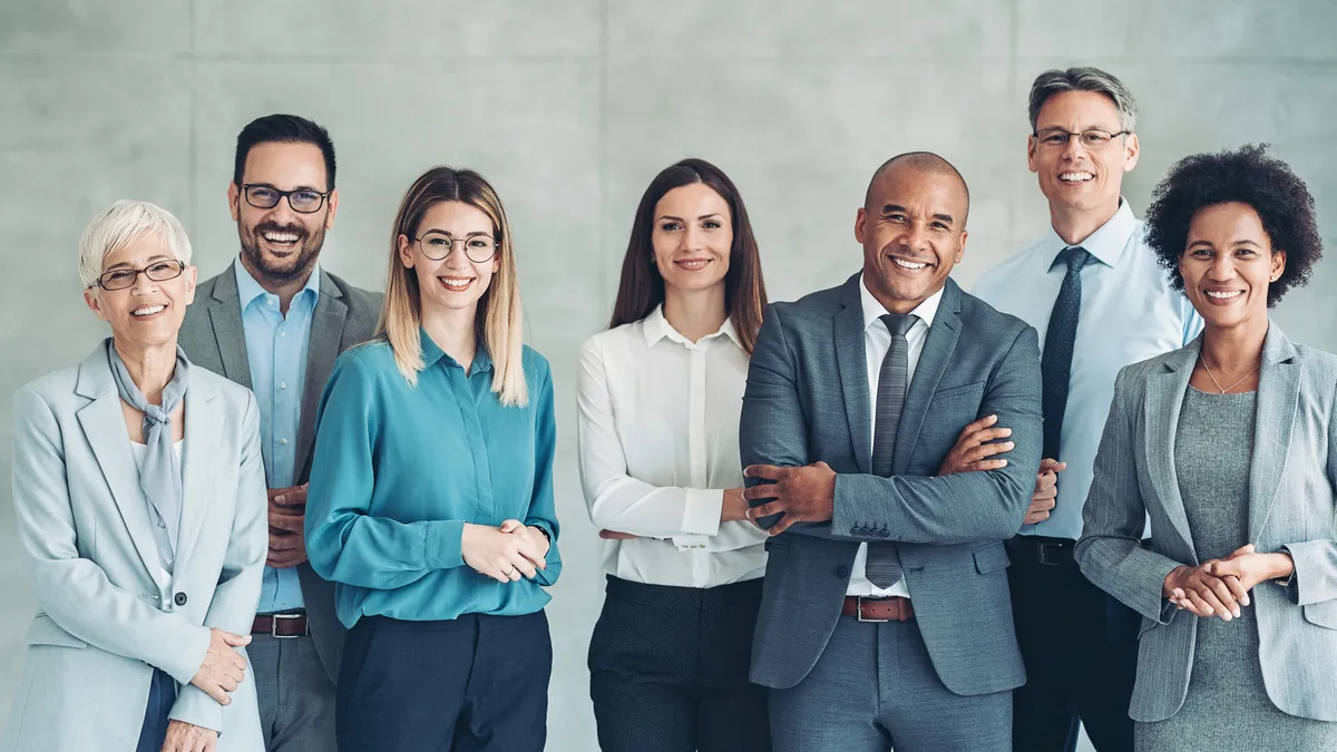 A group of legal professionals stand next to one another