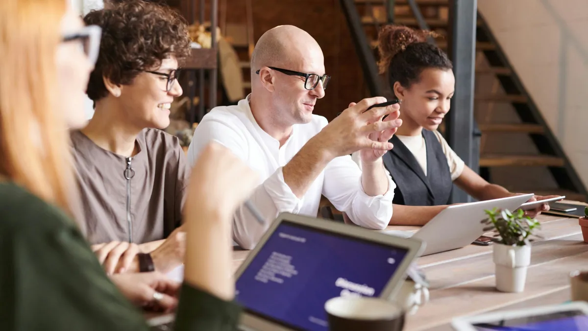 Colleagues sitting around a table in a meeting