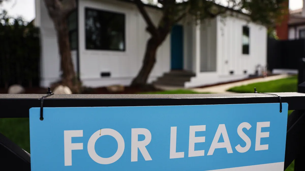 A "For Lease" posted outside a white house