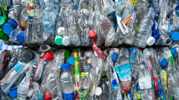 A close up of baled plastic recyclable bottles and containers.