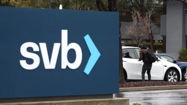 An employee gets into his car after arriving to work to a shuttered Silicon Valley Bank (SVB) headquarters in Santa Clara, California.