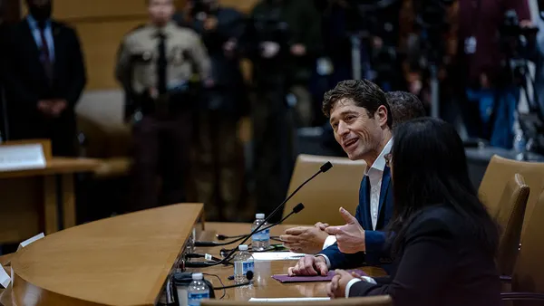 Minneapolis Mayor Jacob Frey speaks into a microphone at a hearing.