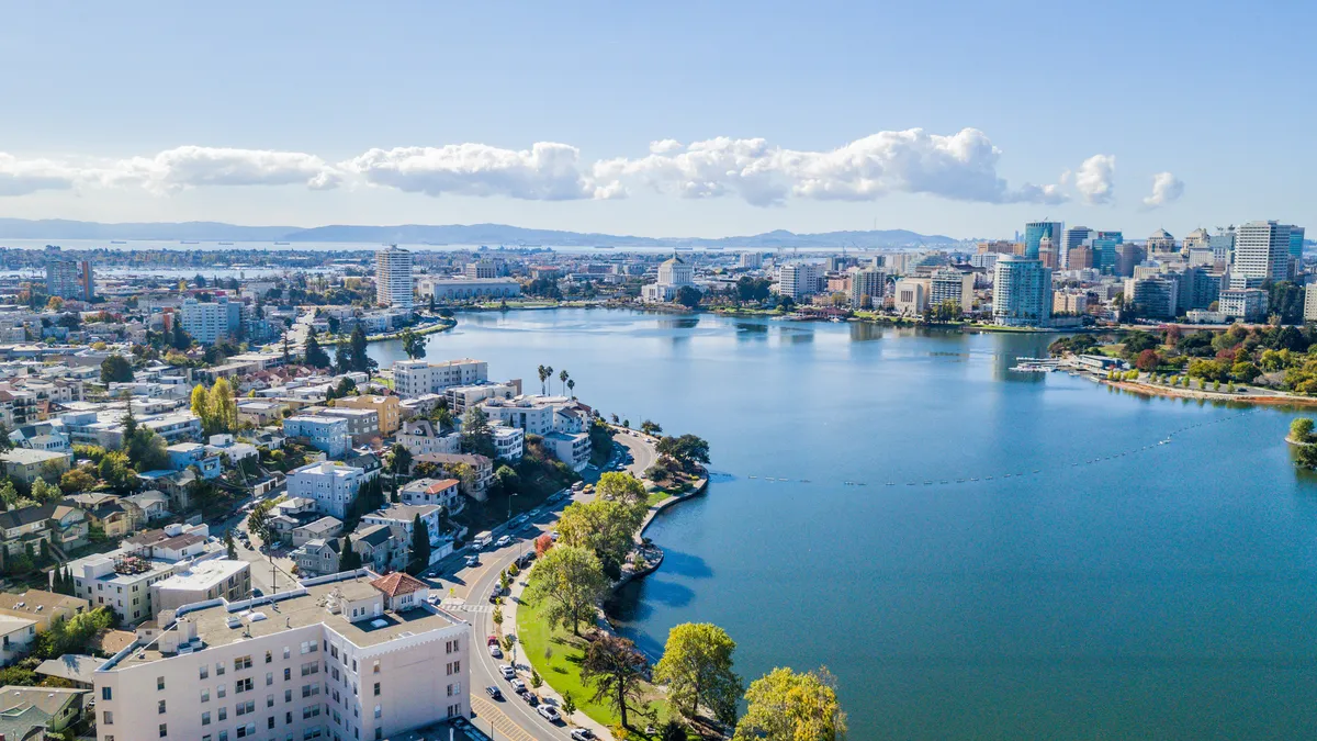 Aerial view above Lake Merritt in Oakland, California. Looking across the lake at downtown Oakland with skyscrapers in the distance.