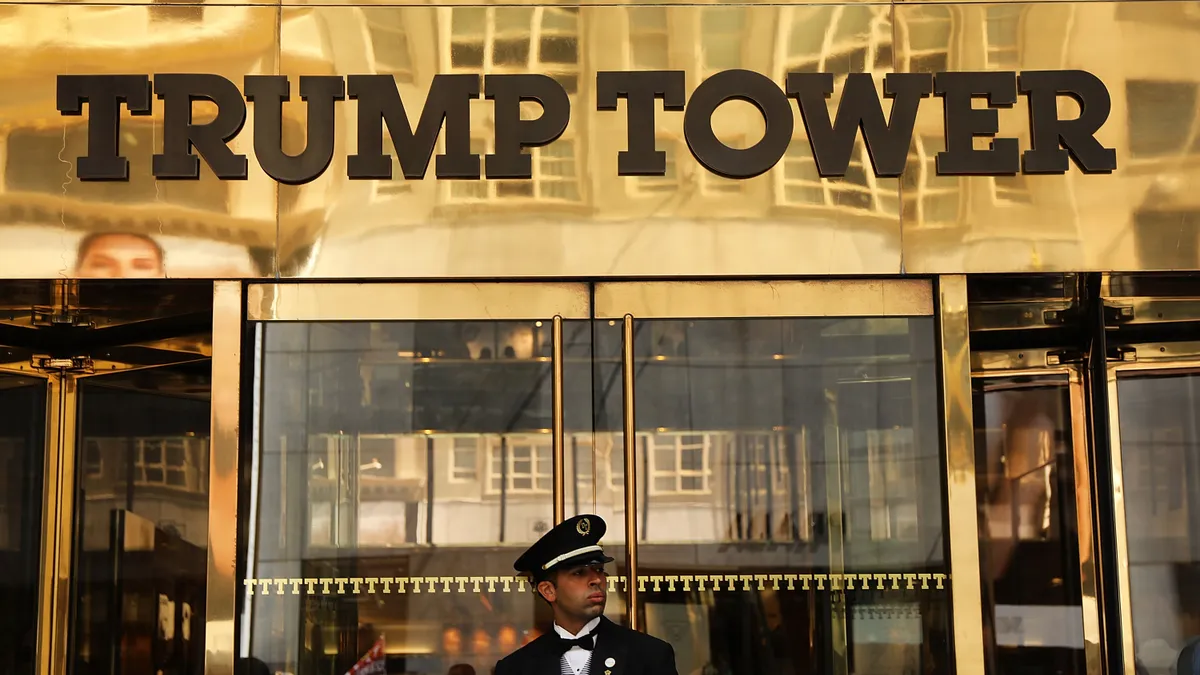 Trump Tower entrance with doorman in foreground.