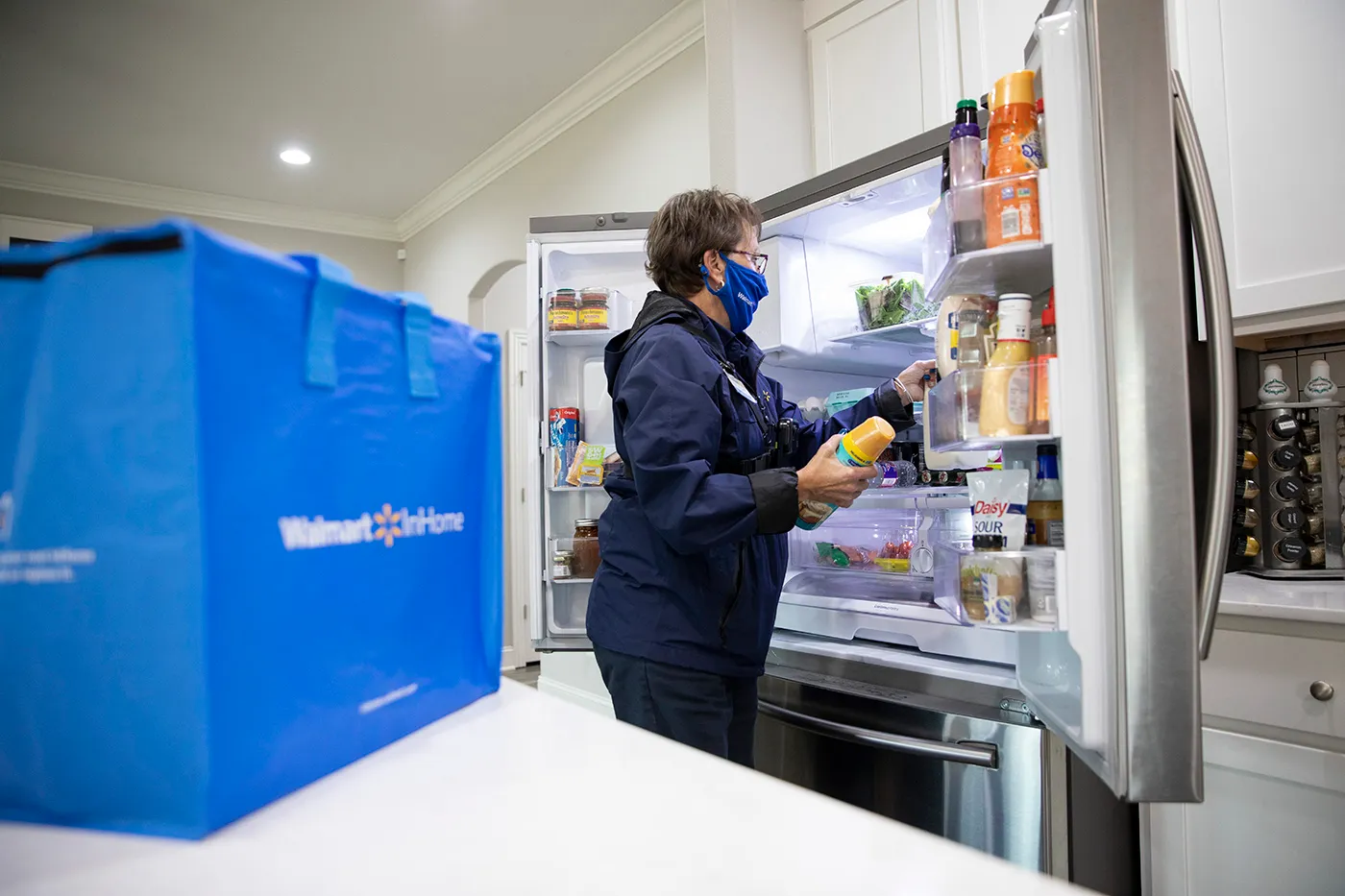 Grocery delivery worker in kitchen