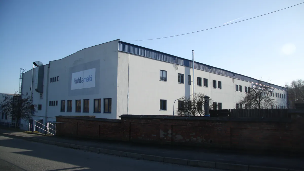 The exterior of an industrial building with Huhtamaki's logo on the side.