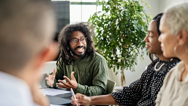 People in a meeting a person talking to everyone