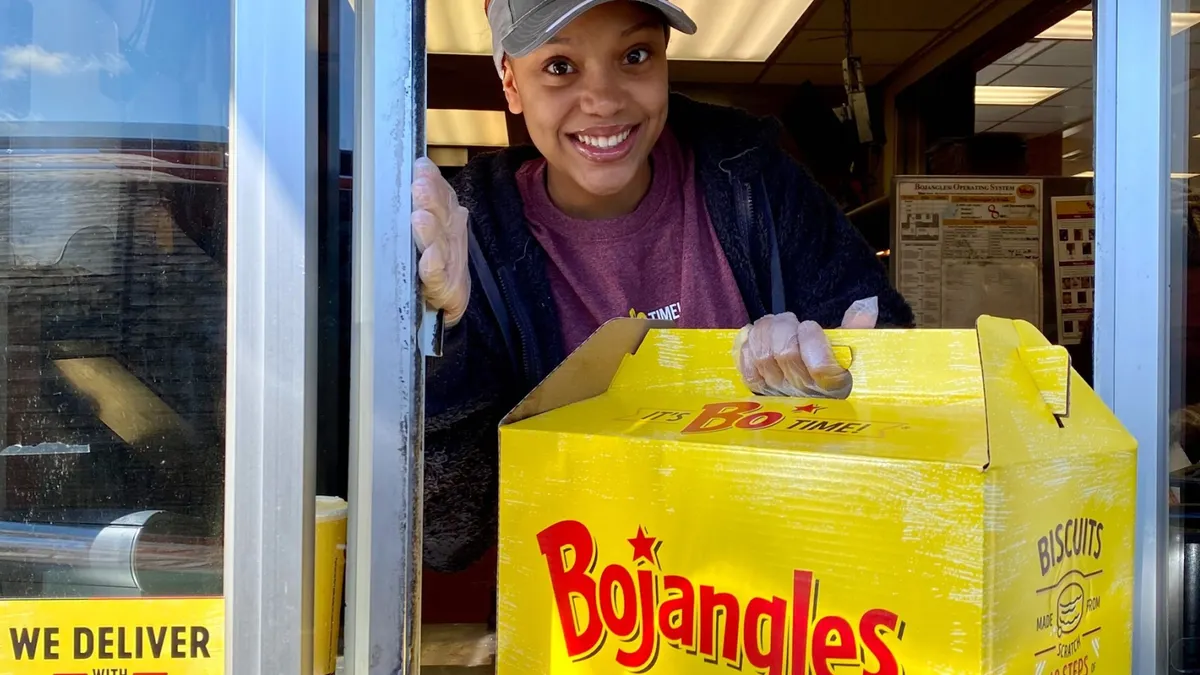 Smiling server with Bojangles box in hand