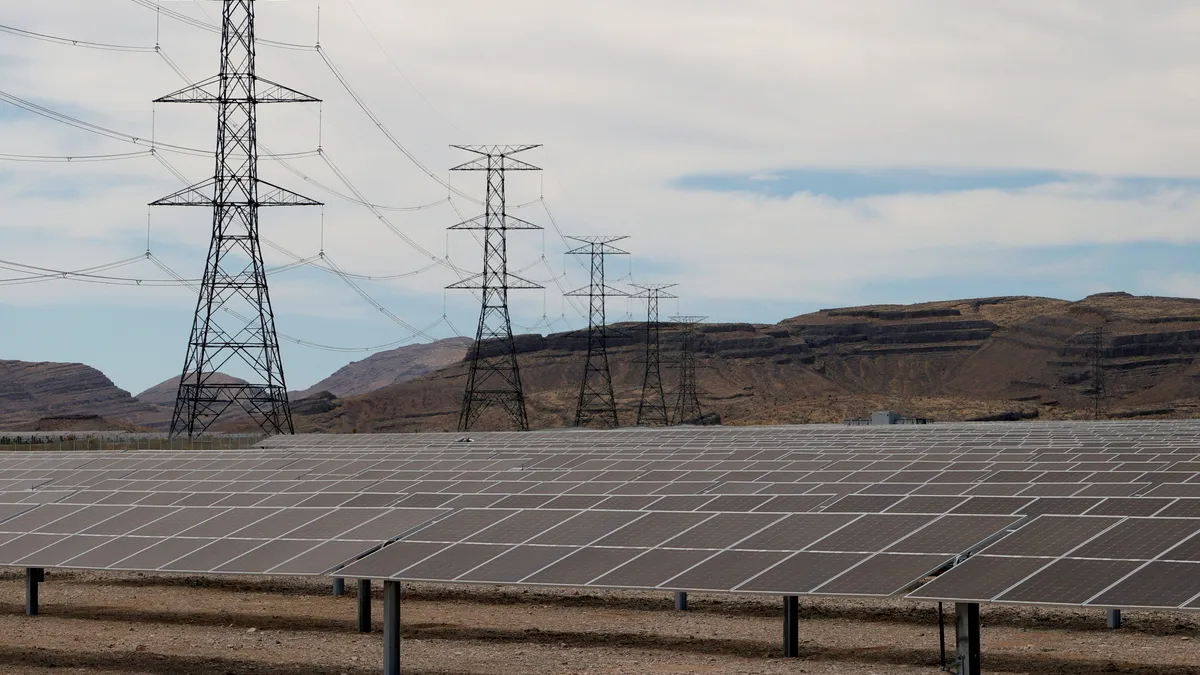 Transmission towers are shown near solar panels from the 100-megawatt MGM Resorts Mega Solar Array after it was launched on June 28, 2021, in Dry Lake Valley, Nevada.