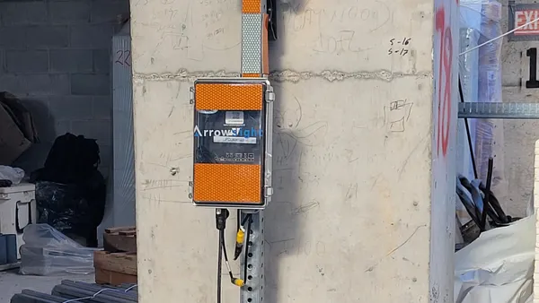 A camera system attached to a concrete column on a construction jobsite.
