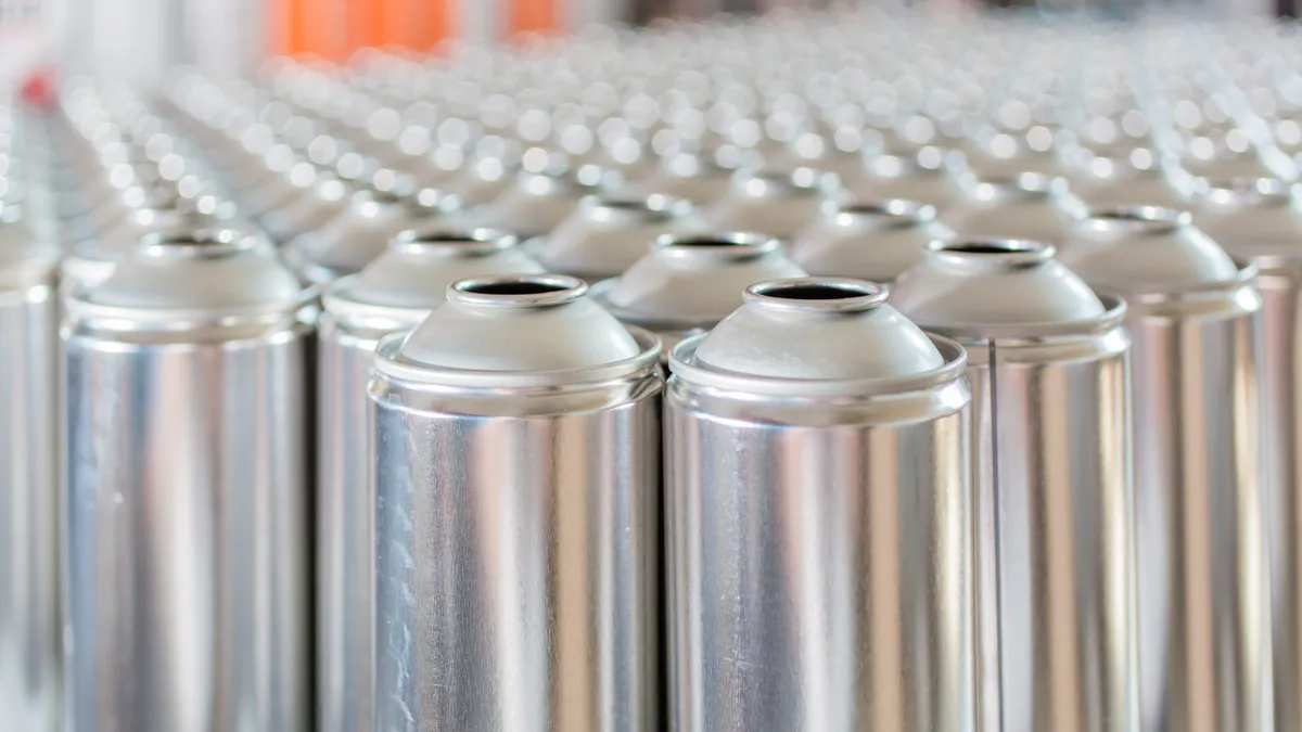 Row of tall metallic aerosol cans