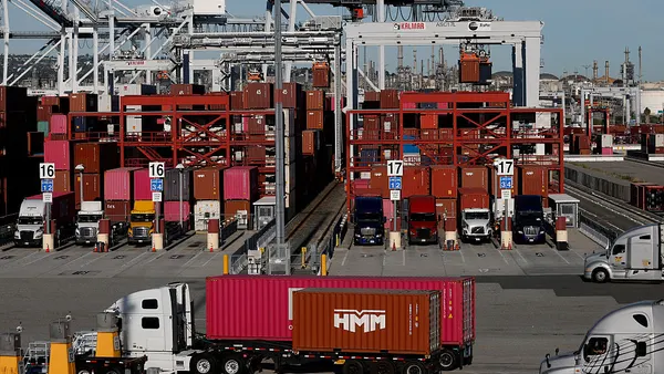 Several trucks moving at a TraPac terminal in Los Angeles.