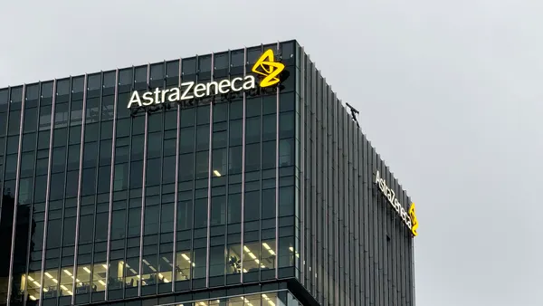 An AstraZeneca logo stands atop an office building in Shanghai, China.