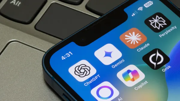Assorted AI apps, including ChatGPT, Gemini, Claude, Perplexity, Meta AI, Microsoft Copilot, and Grok, are seen on the screen of an iPhone