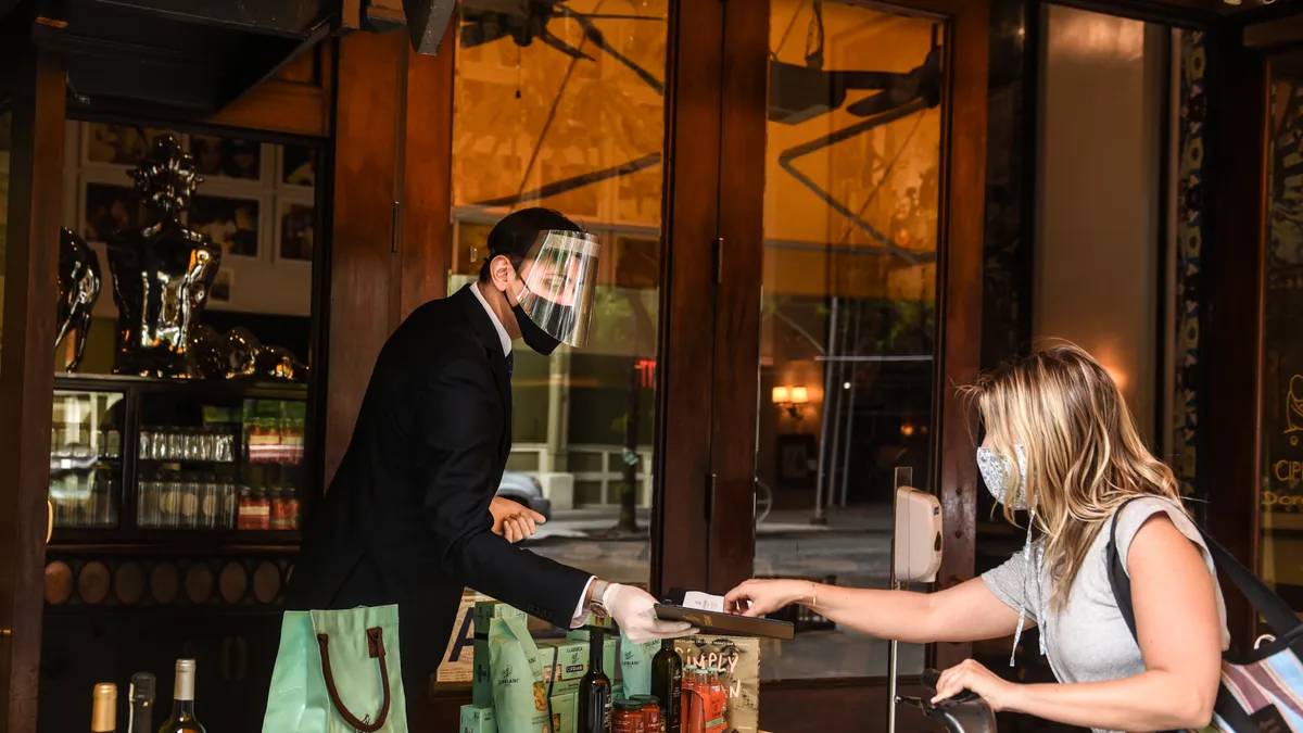 A customer pays for a food order during the pandemic.