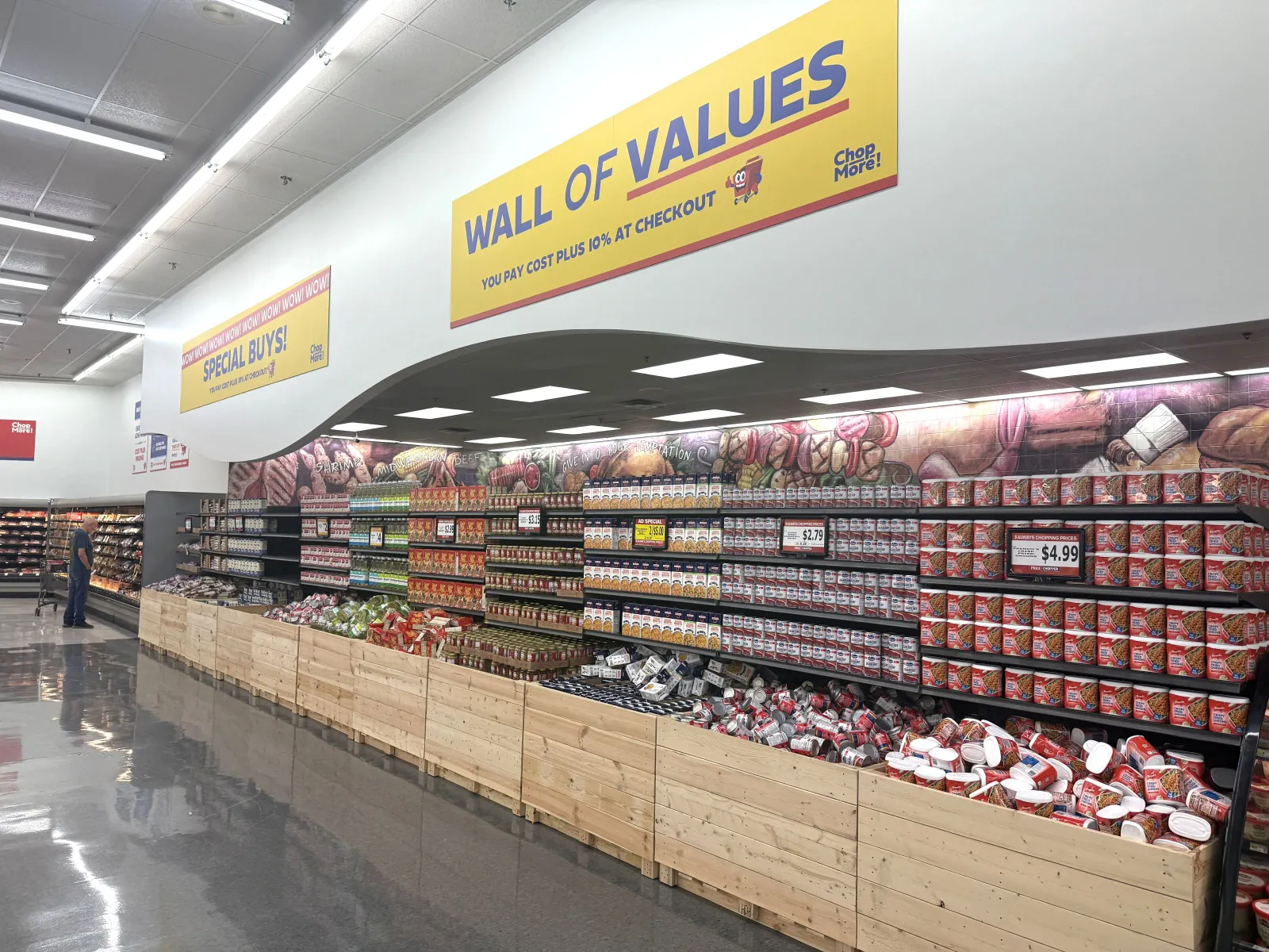 Food on display in a grocery store beneath a sign that says "Wall of Values."