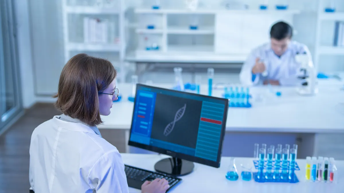 Two Scientists analyzing chemical data to researchers medicine for healthcare industry at laboratory