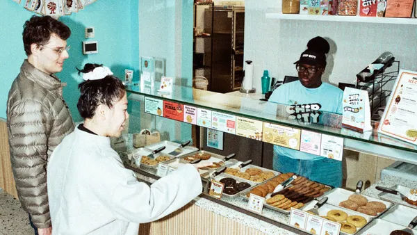 Customers ordering at the counter of a cookie store.