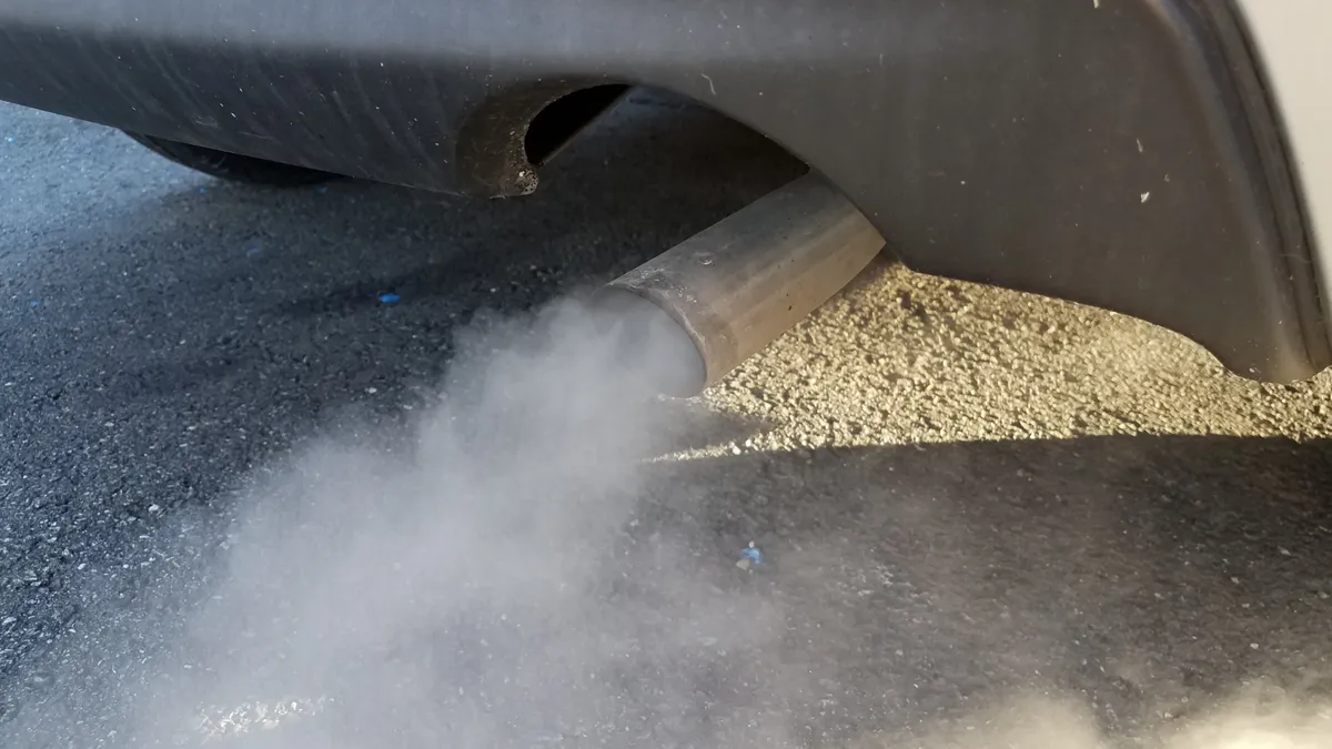 A vehicle's tailpipe emitting exhaust.