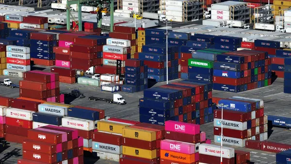 In an aerial view, shipping containers are stacked on a dock at the Port of Oakland on December 09, 2024 in Oakland, California.