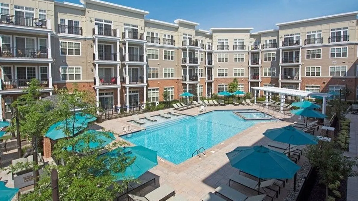 Mid-rise apartment property surrounding a pool.