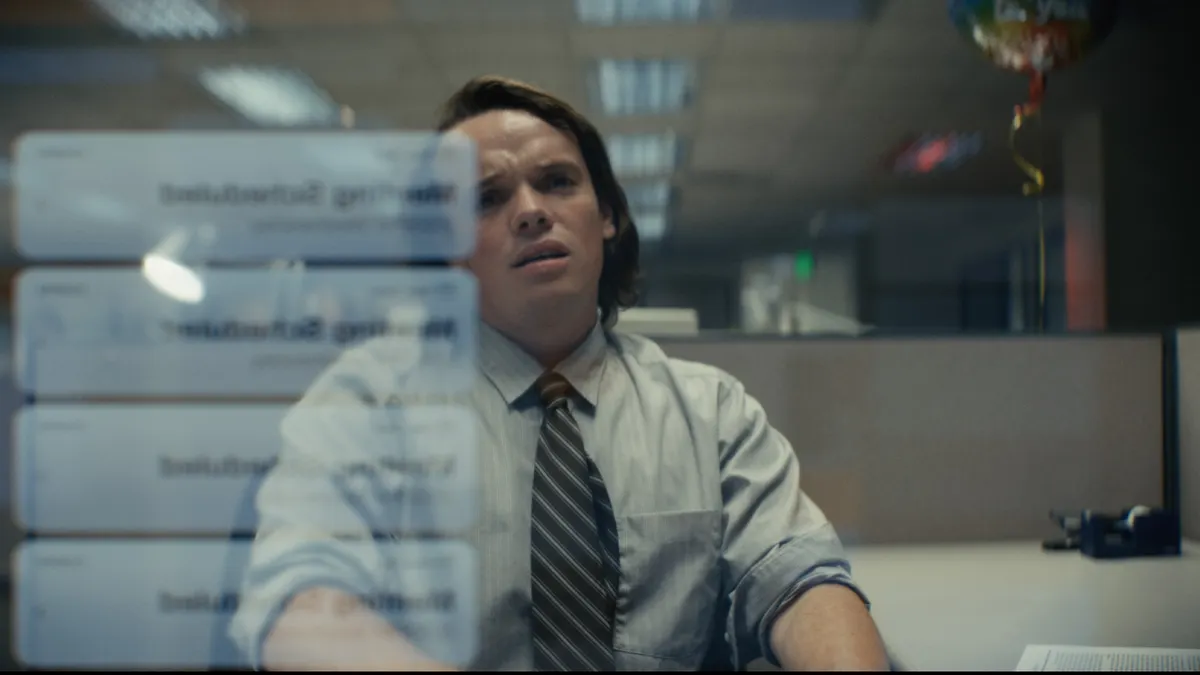 An office worker becomes overwhelmed at the amount of meeting notifications he is receiving.