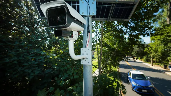 Camera on a pole with a solar panel above it