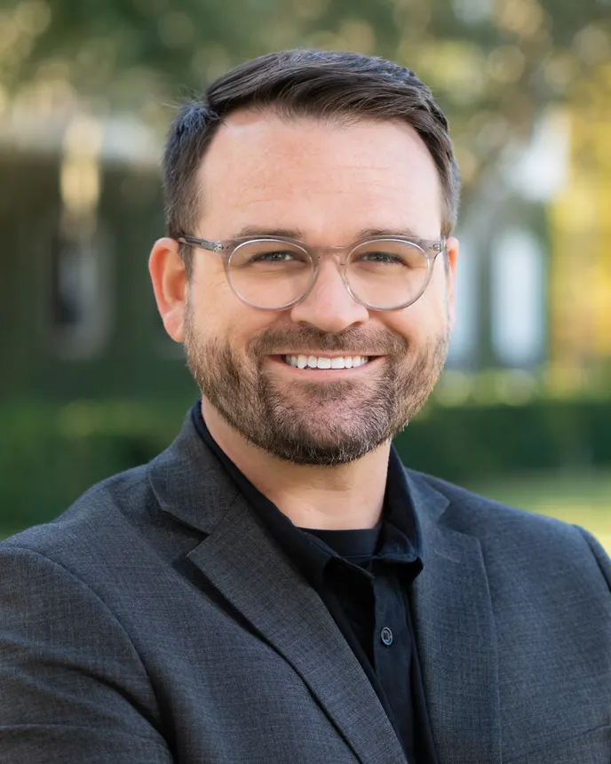 Headshot of a man in professional attire.