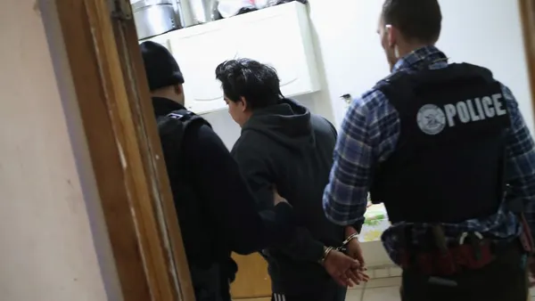 U.S. Immigration and Customs Enforcement officers arrest an undocumented immigrant during a raid.