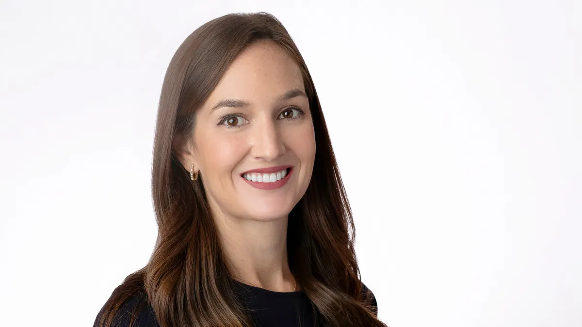 A professional headshot of Caitlin Gossens.