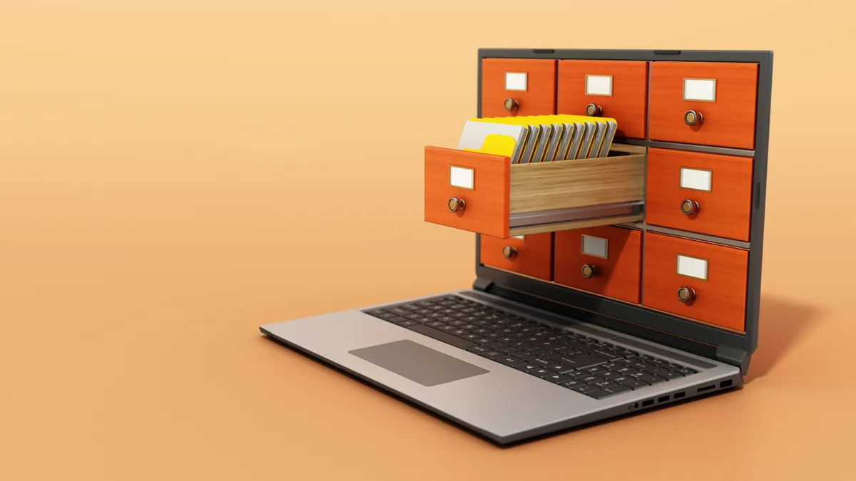 File cabinets or catalog drawers inside the laptop screen. Folders standing inside the drawer.