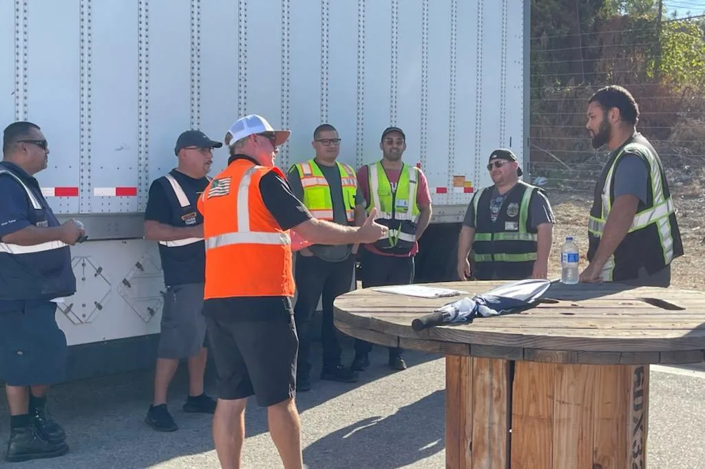 An instructor talks to students enrolled in a Yellow driver training academy at a distribution center Pico Rivera, California.