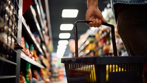 Close up of man with shopping basket buying groceries at the store.