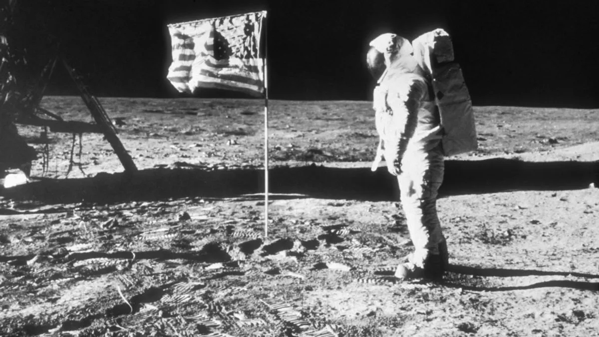 American astronaut Edwin "Buzz" Aldrin walks on the surface of the moon next to the American flag during the NASA Apollo 11 mission on July 20, 1969.