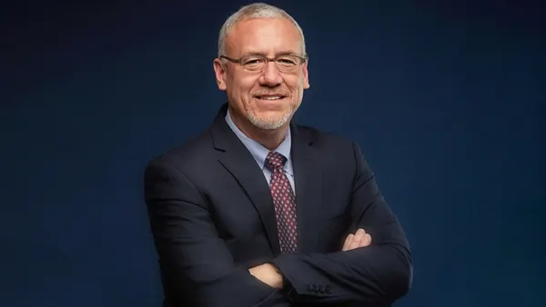 a headshot of mark ryland in business attire