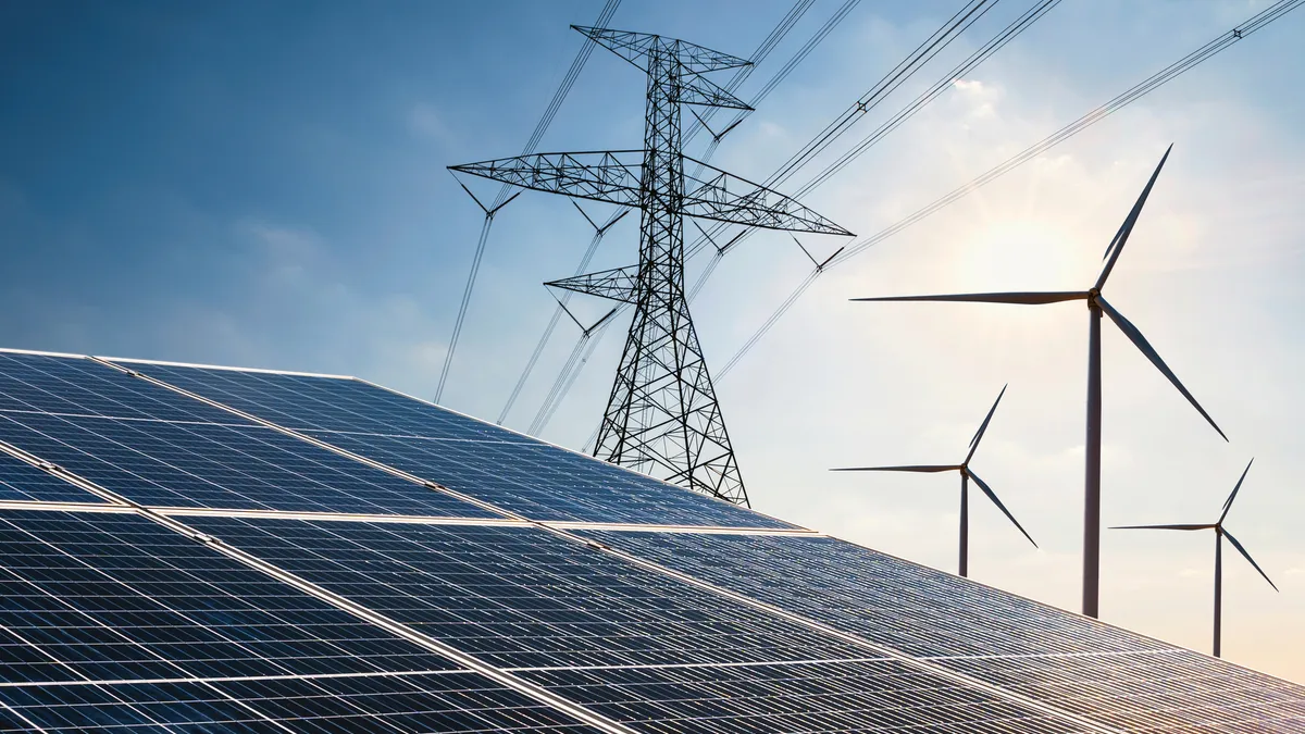 Solar panels, wind turbines and a transmission line.