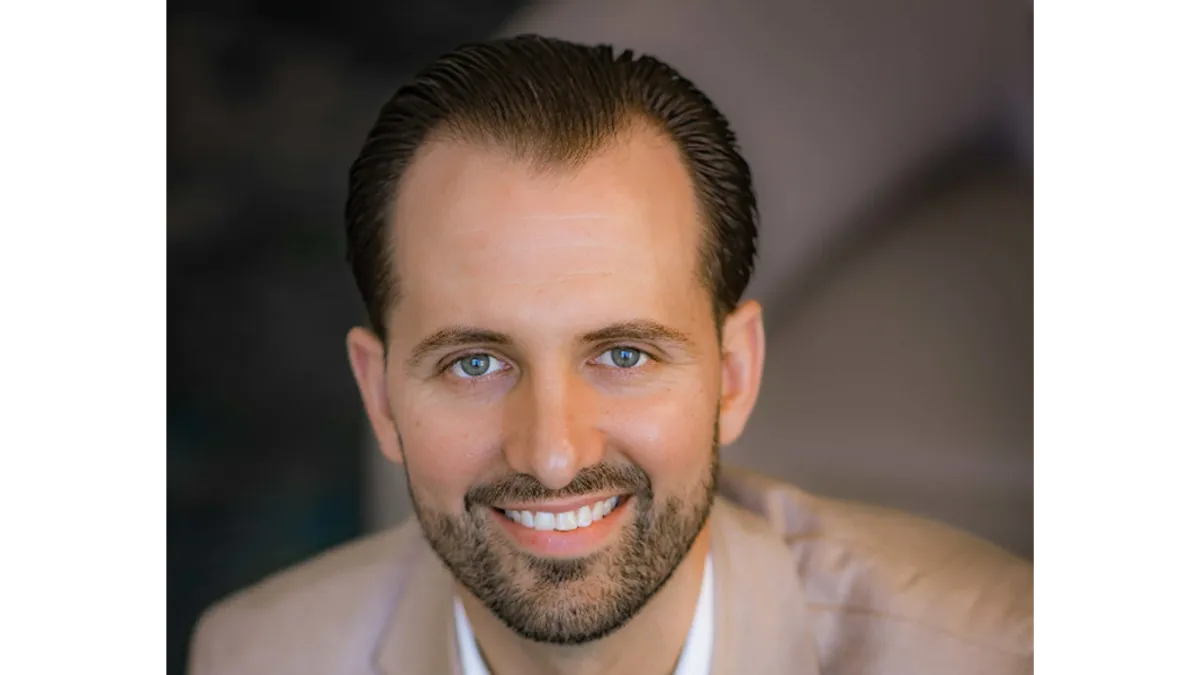 An image of a man wearing a beige suit.