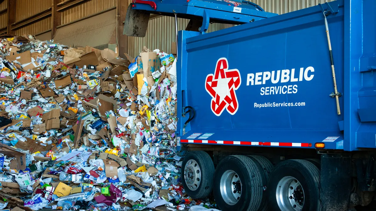 Republic Services truck tipping load of recyclables