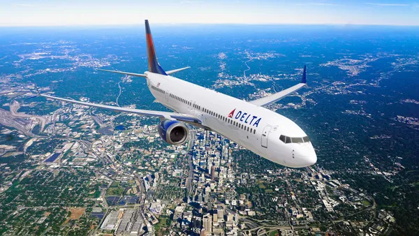 A Delta Airlines plane flying in the sky.