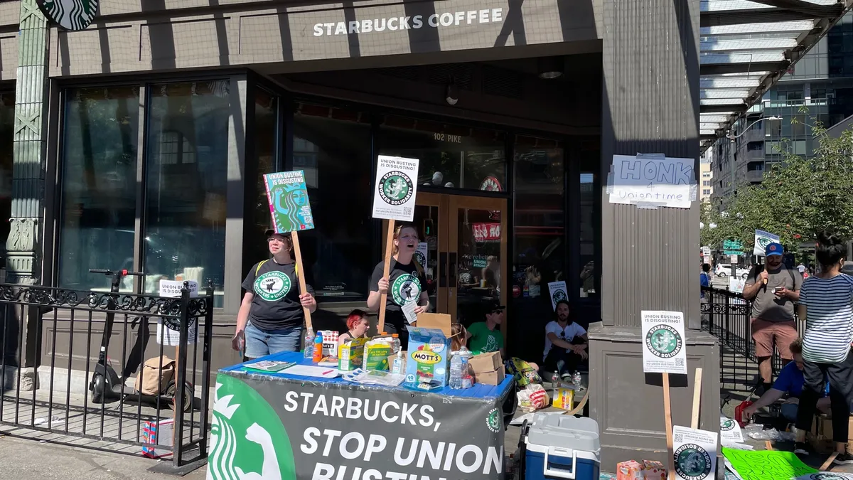 Starbucks workers on strike outside a Seattle Starbucks in June 2022.