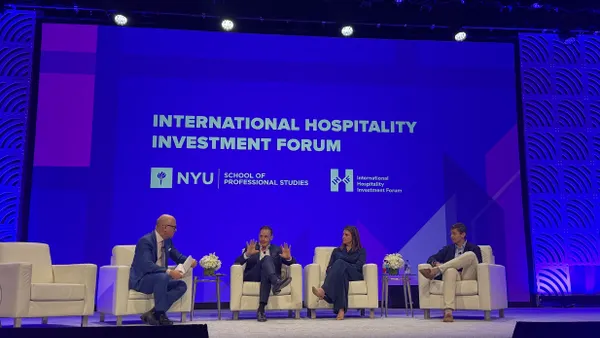Panelists speaking at a conference