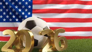 A soccer ball and bronze "2026" lettering in front of an American flag.