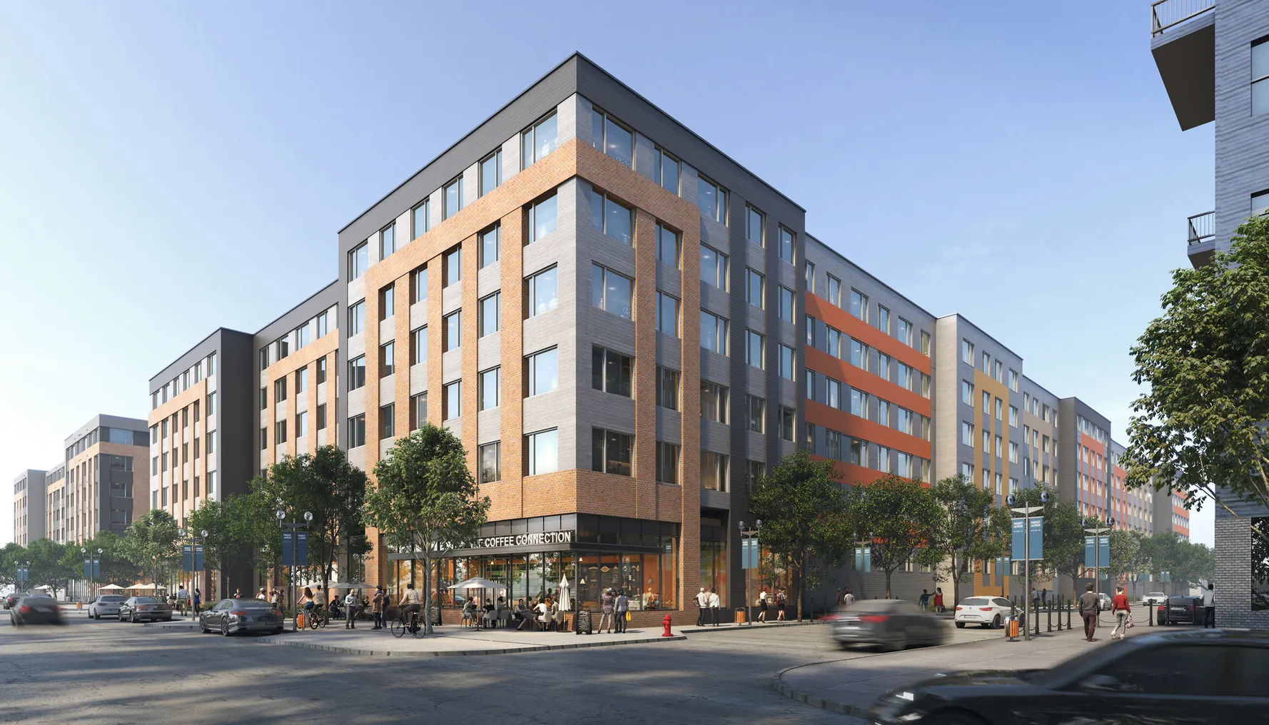 Six-story brown and grey apartment building with cars and street in the foreground.