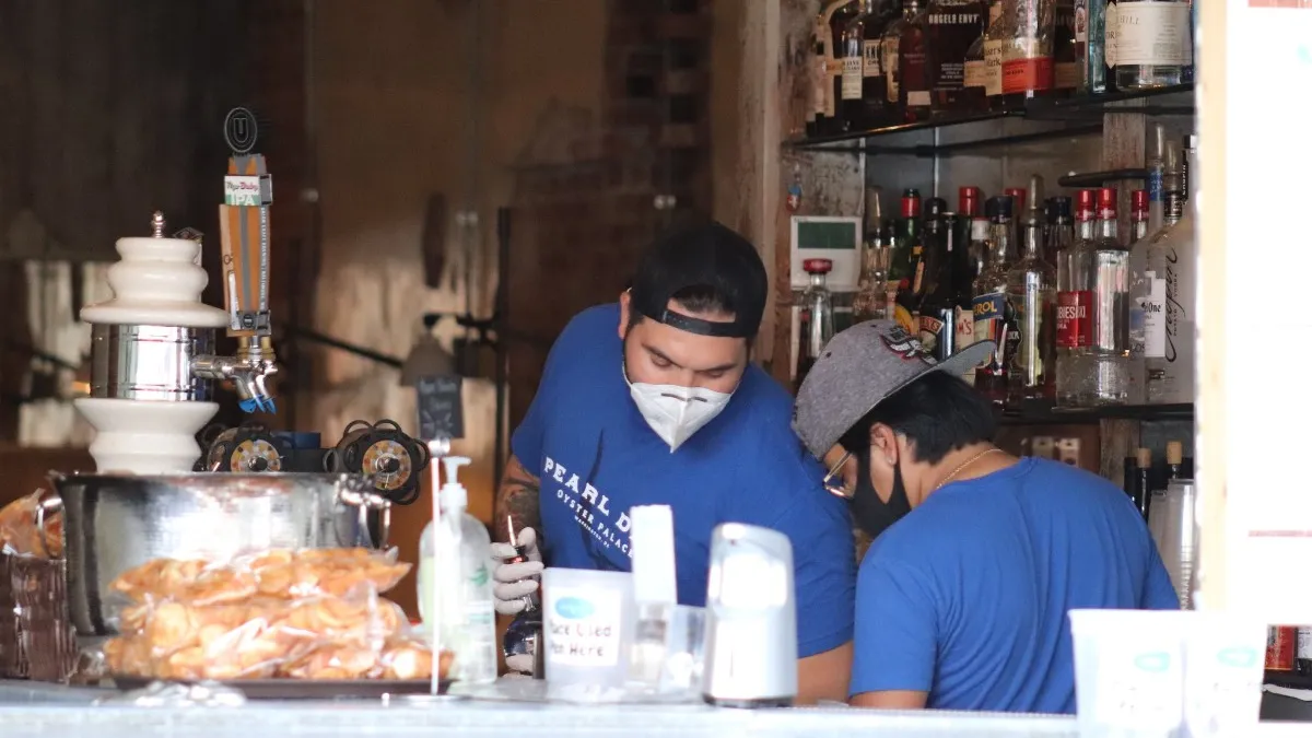 Two restaurant employees at Pearl Dive Oyster Palace in Baltimore, Maryland