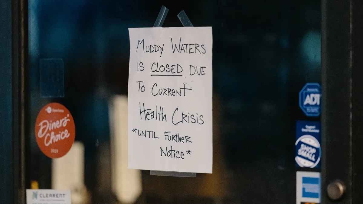 A sign at Muddy Waters Bar & Eatery in Minneapolis, Minnesota, during the novel coronavirus pandemic of 2020.